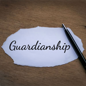 Handwritten word 'Guardianship' on a torn piece of paper symbolizing legal responsibility